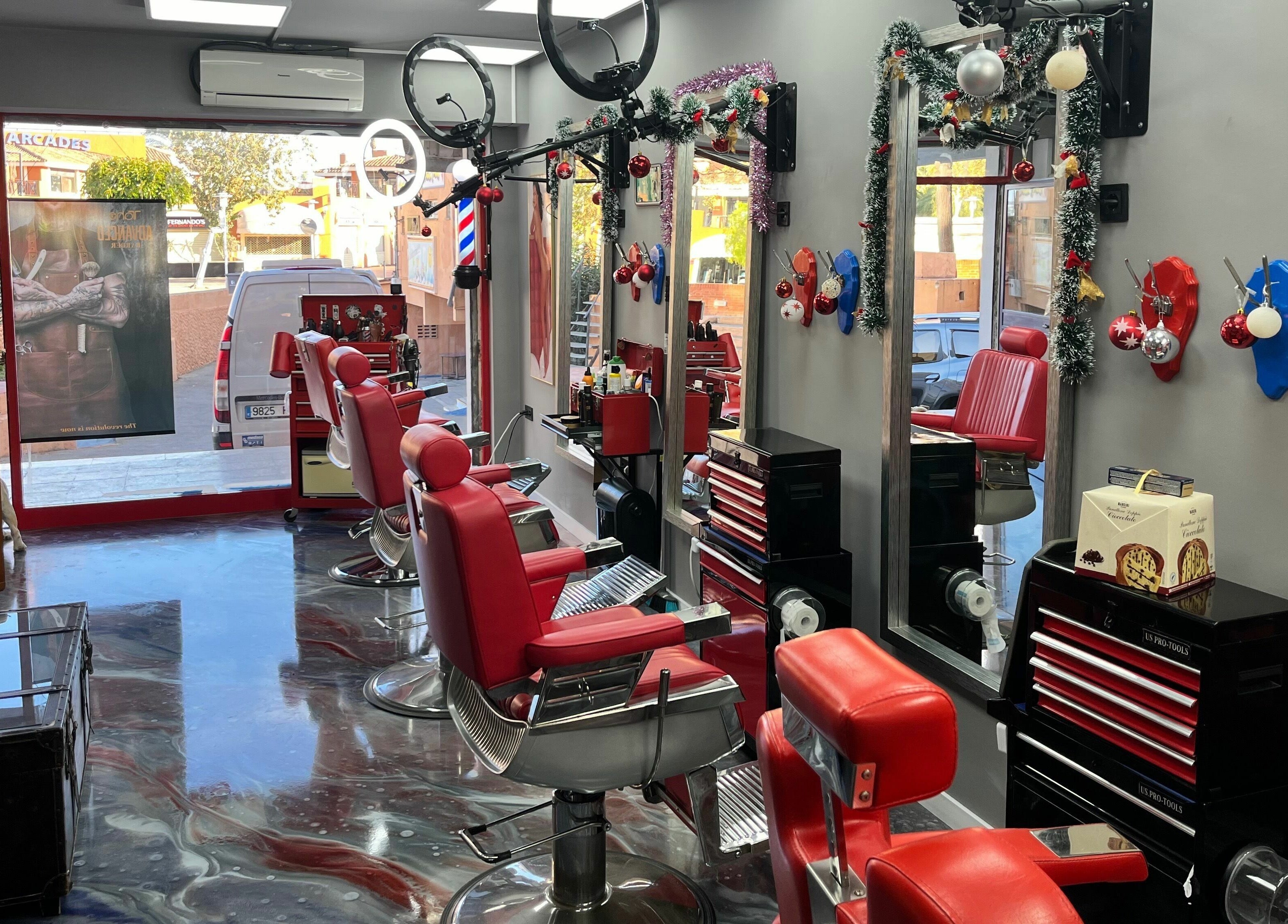 Interior of Mr. Lee's Barbershop in Magaluf, Illes Balears, ES with red chairs and modern decor.