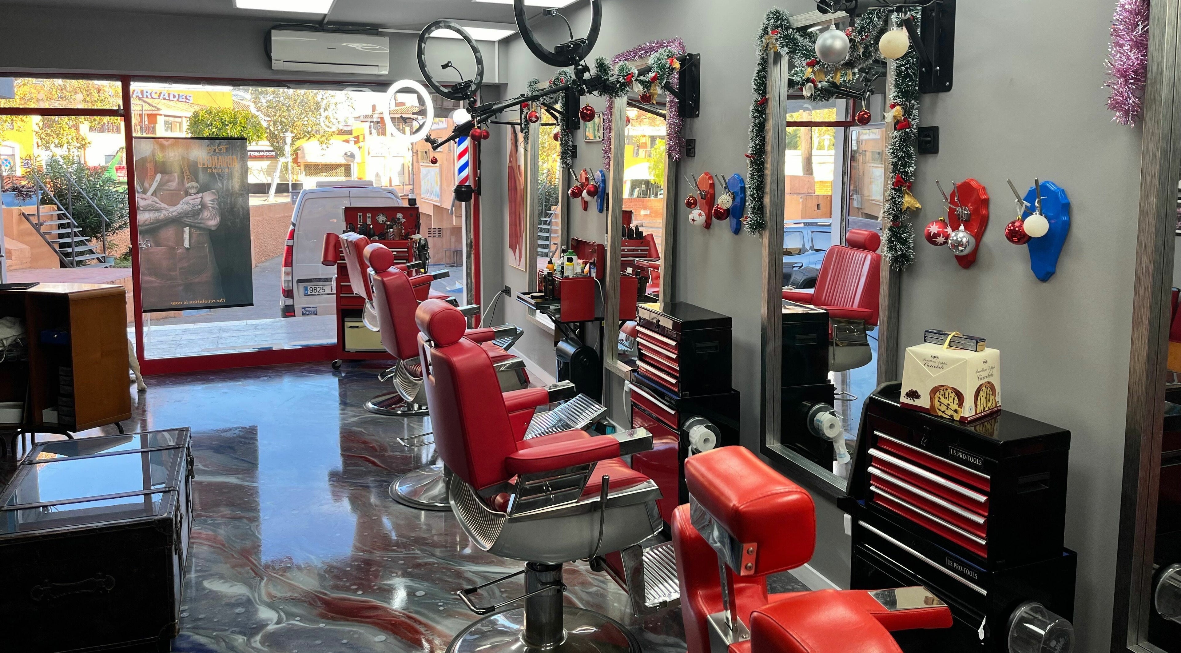 Interior of Mr. Lee's Barbershop in Magaluf, Illes Balears, ES with red chairs and modern decor.