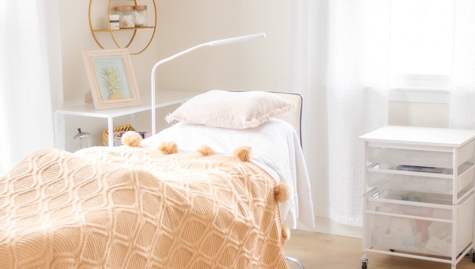 Lashed+ treatment room with cozy bed and decor in Norwell, Massachusetts, US, offering a serene atmosphere.