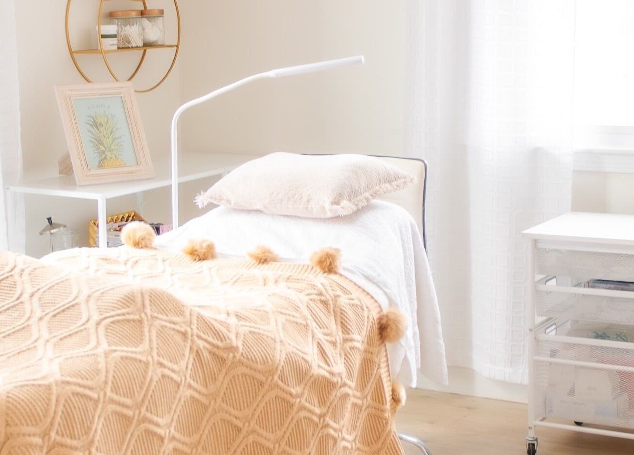 Lashed+ treatment room with cozy bed and decor in Norwell, Massachusetts, US, offering a serene atmosphere.