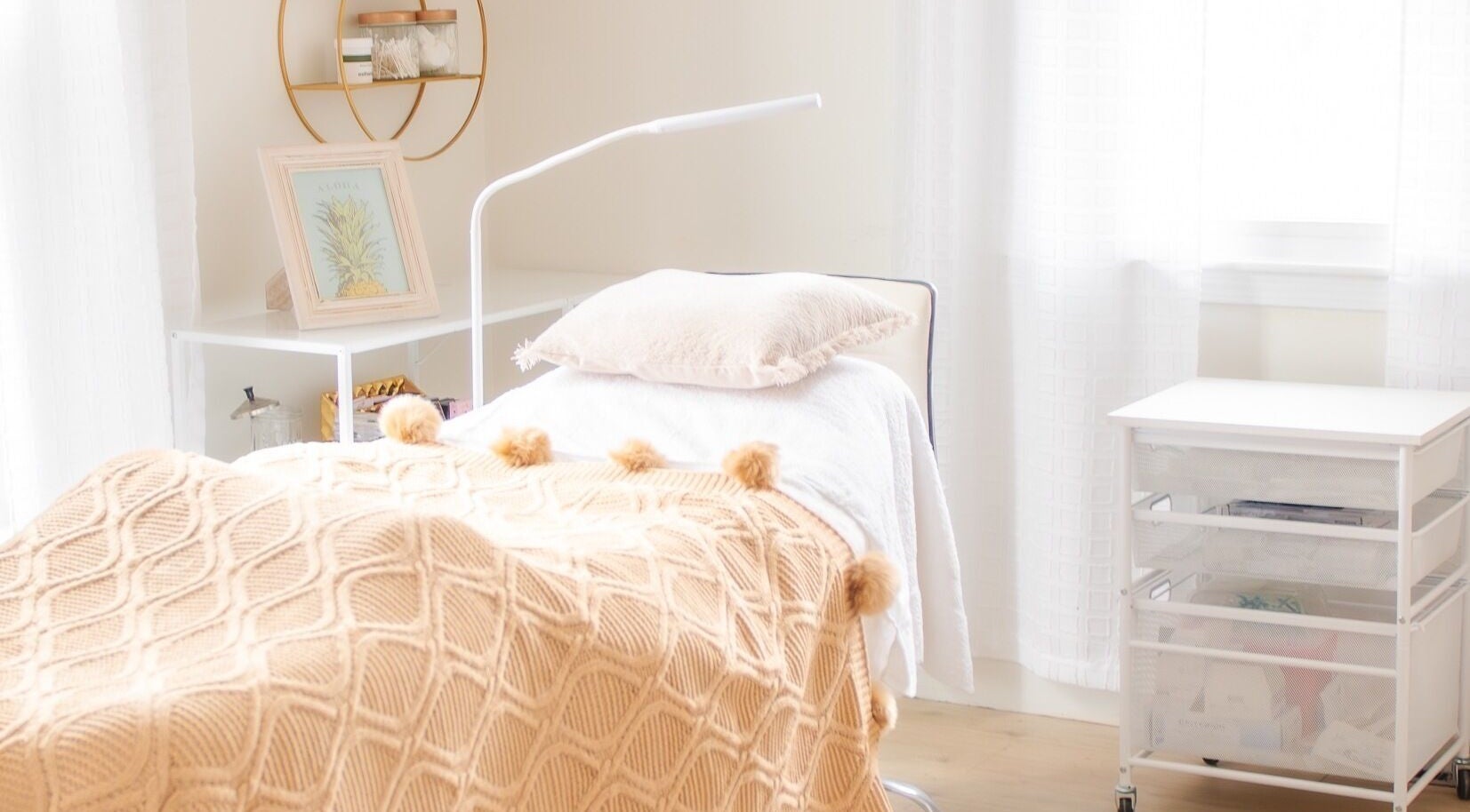 Lashed+ treatment room with cozy bed and decor in Norwell, Massachusetts, US, offering a serene atmosphere.