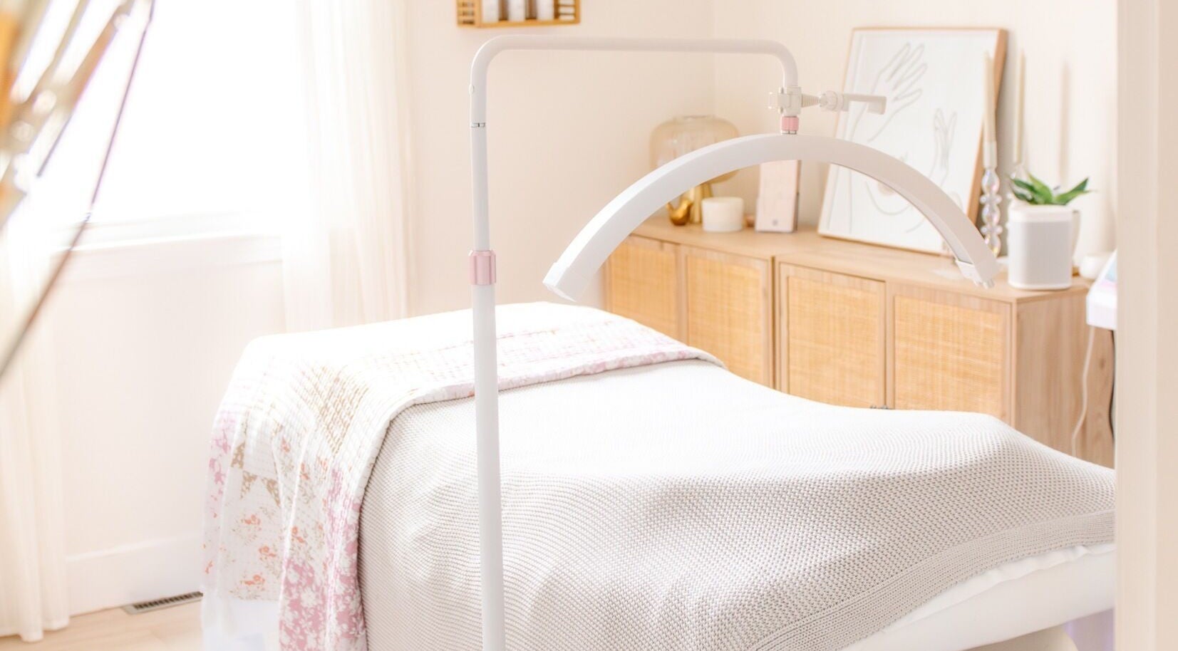 A serene treatment room at Lashed+ in Norwell, Massachusetts, US, featuring a comfortable bed and soft lighting.