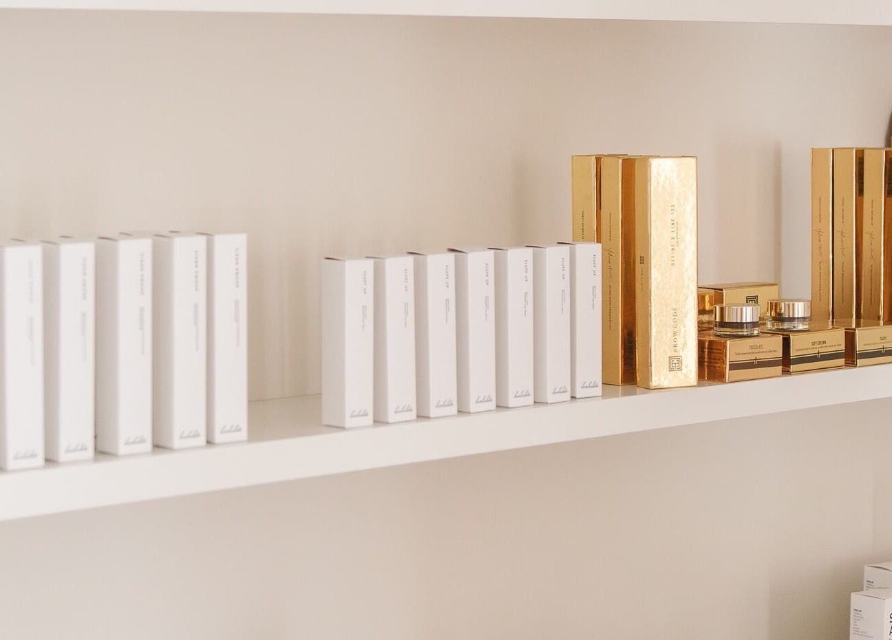Display of luxurious beauty products on a shelf at Lashed+ in Norwell, Massachusetts, US.