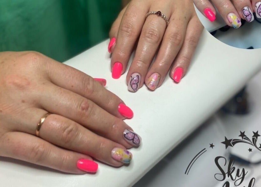 Elegant butterfly nail art at Sky 4 Nails, located in Poole, England, GB, showcasing vibrant pink designs.