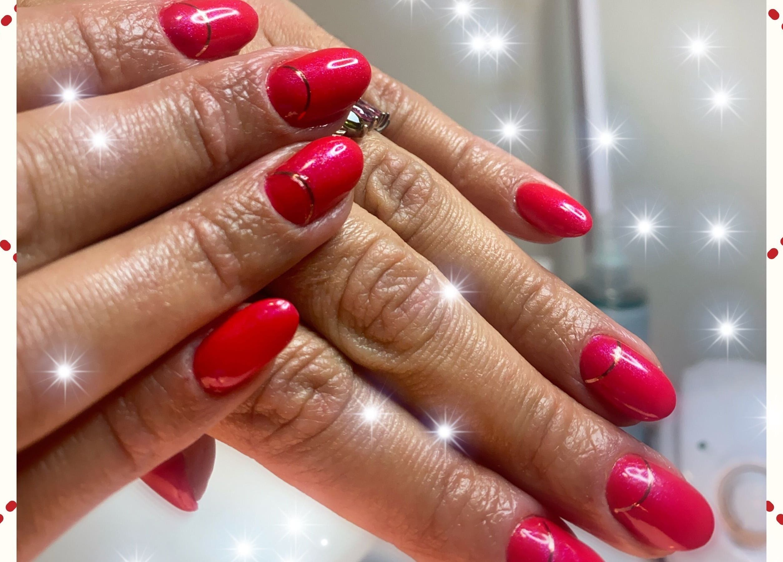 Red manicured nails with sparkles at Sky 4 Nails, Poole, England, GB.