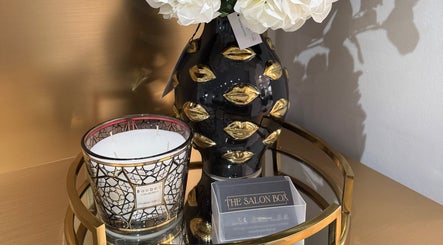 Elegant decor with candle and floral vase at The Salon Box, Brentwood, England, GB.