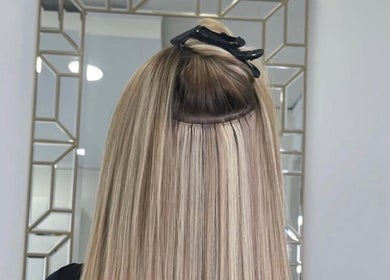 Blonde hair extensions at The Salon Box, Brentwood, England, GB offer sleek, luxurious styling.