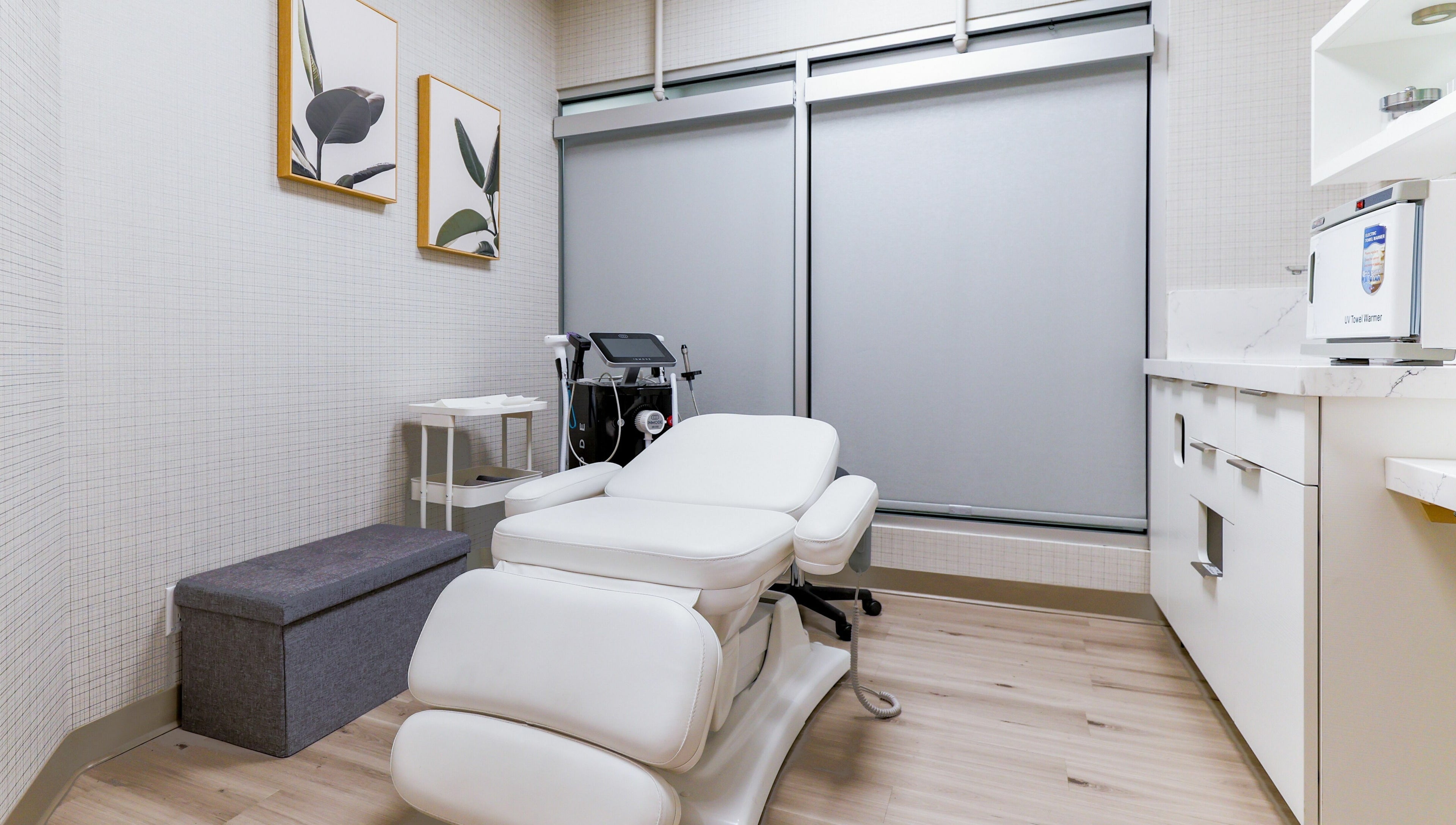 Modern treatment room at Eye Spa Aesthetics, Calgary, Alberta, CA with a relaxing white chair and elegant decor.
