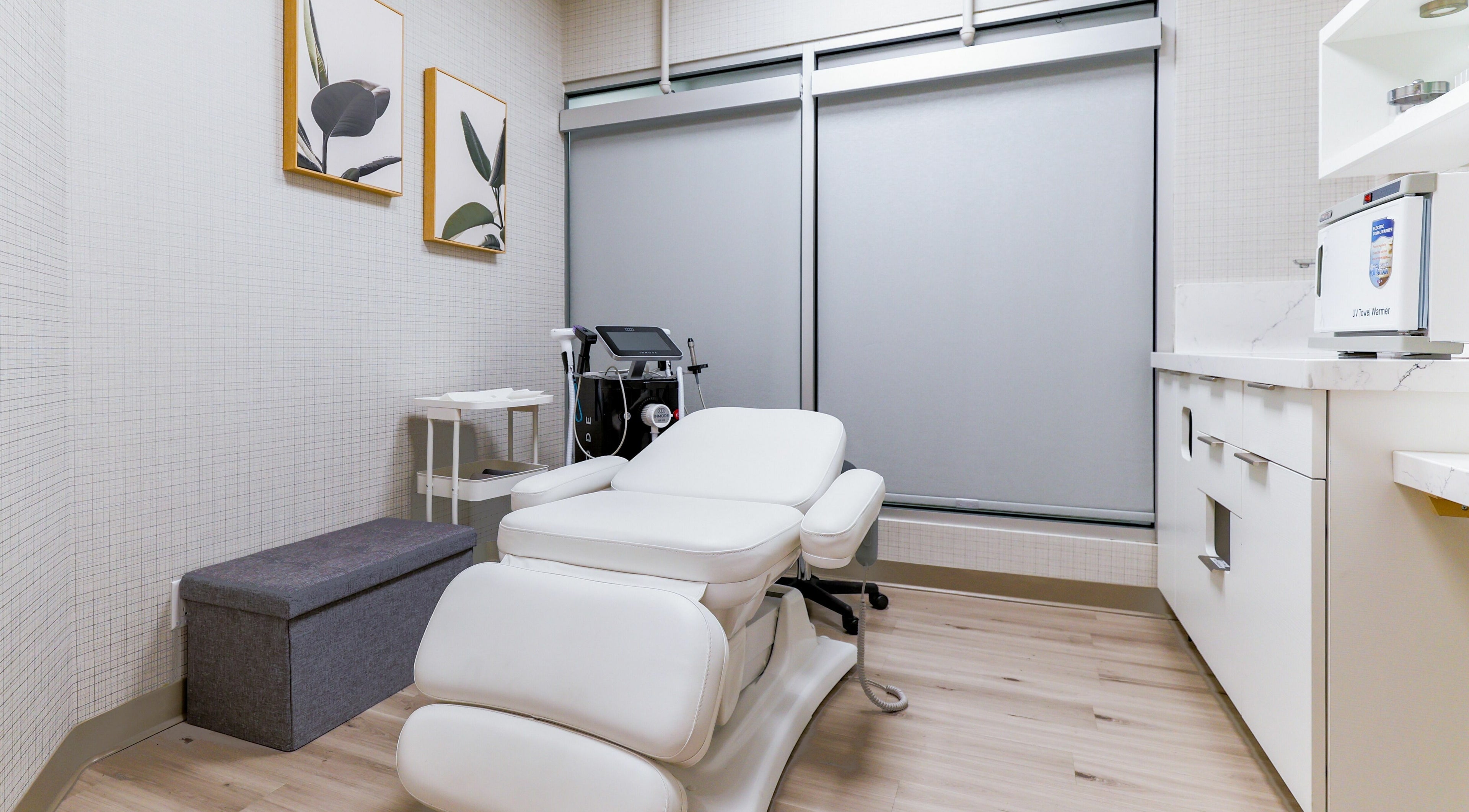 Modern treatment room at Eye Spa Aesthetics, Calgary, Alberta, CA with a relaxing white chair and elegant decor.