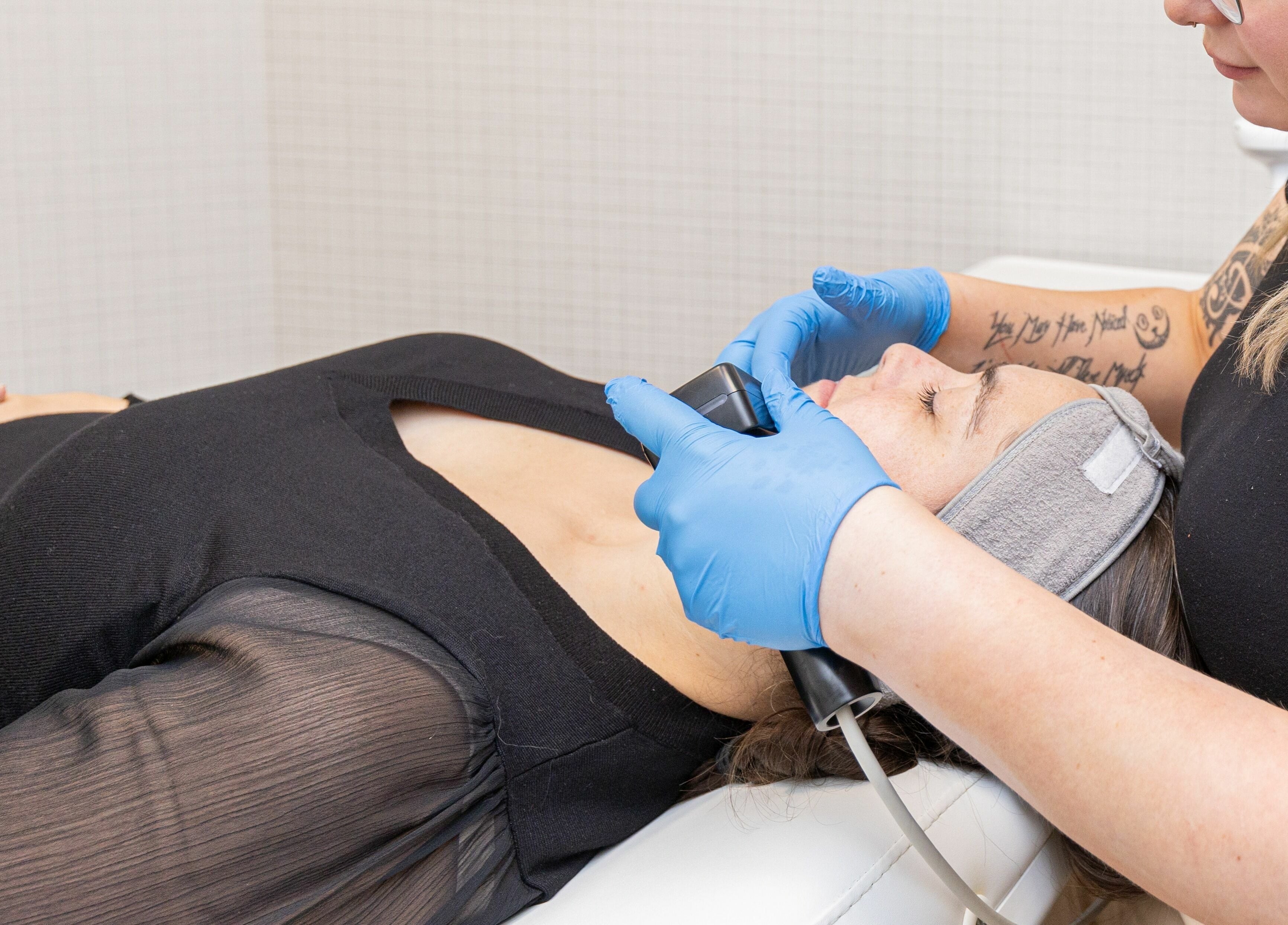 Client enjoys facial treatment at Eye Spa Aesthetics, Calgary, Alberta, CA for radiant skin.