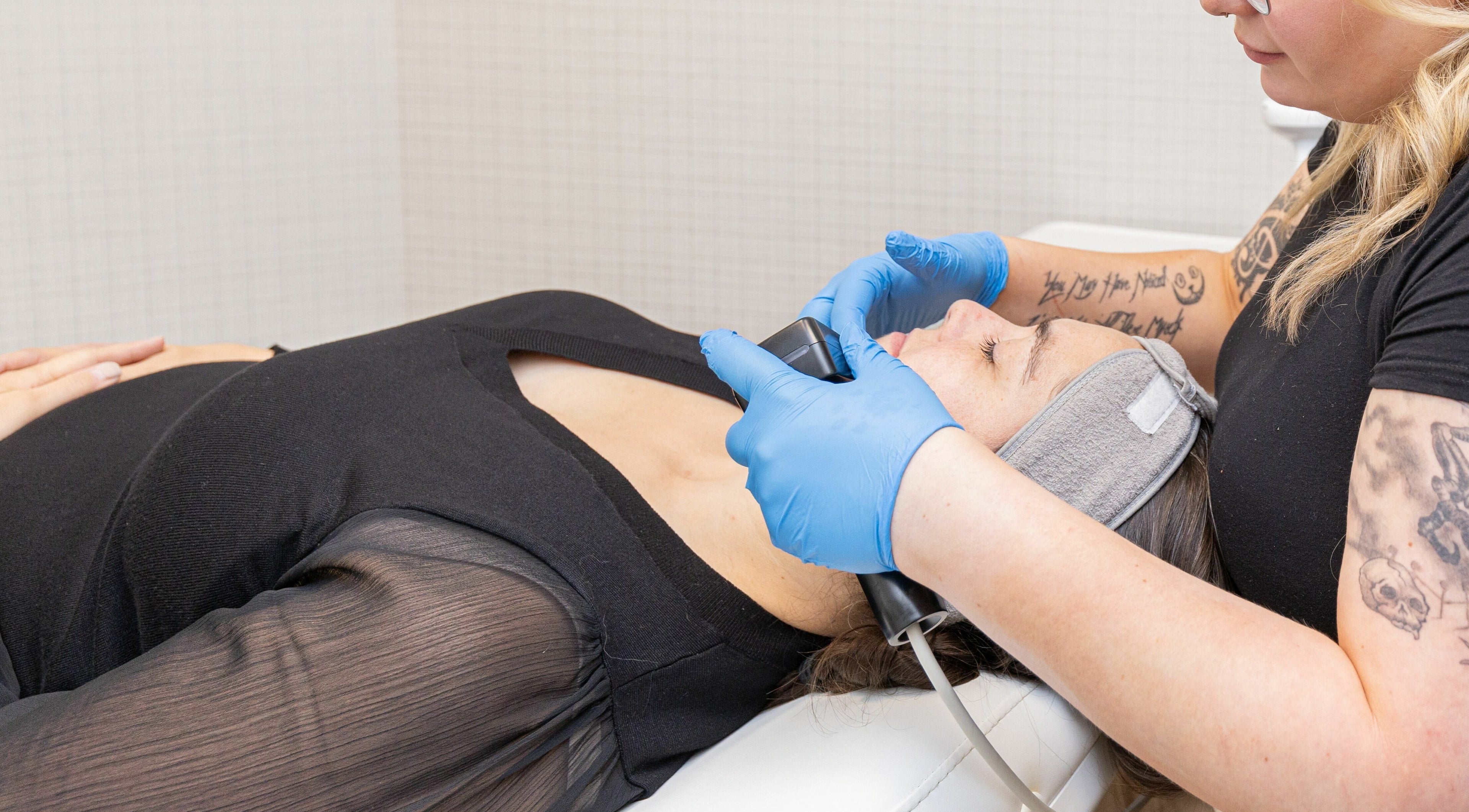 Client enjoys facial treatment at Eye Spa Aesthetics, Calgary, Alberta, CA for radiant skin.