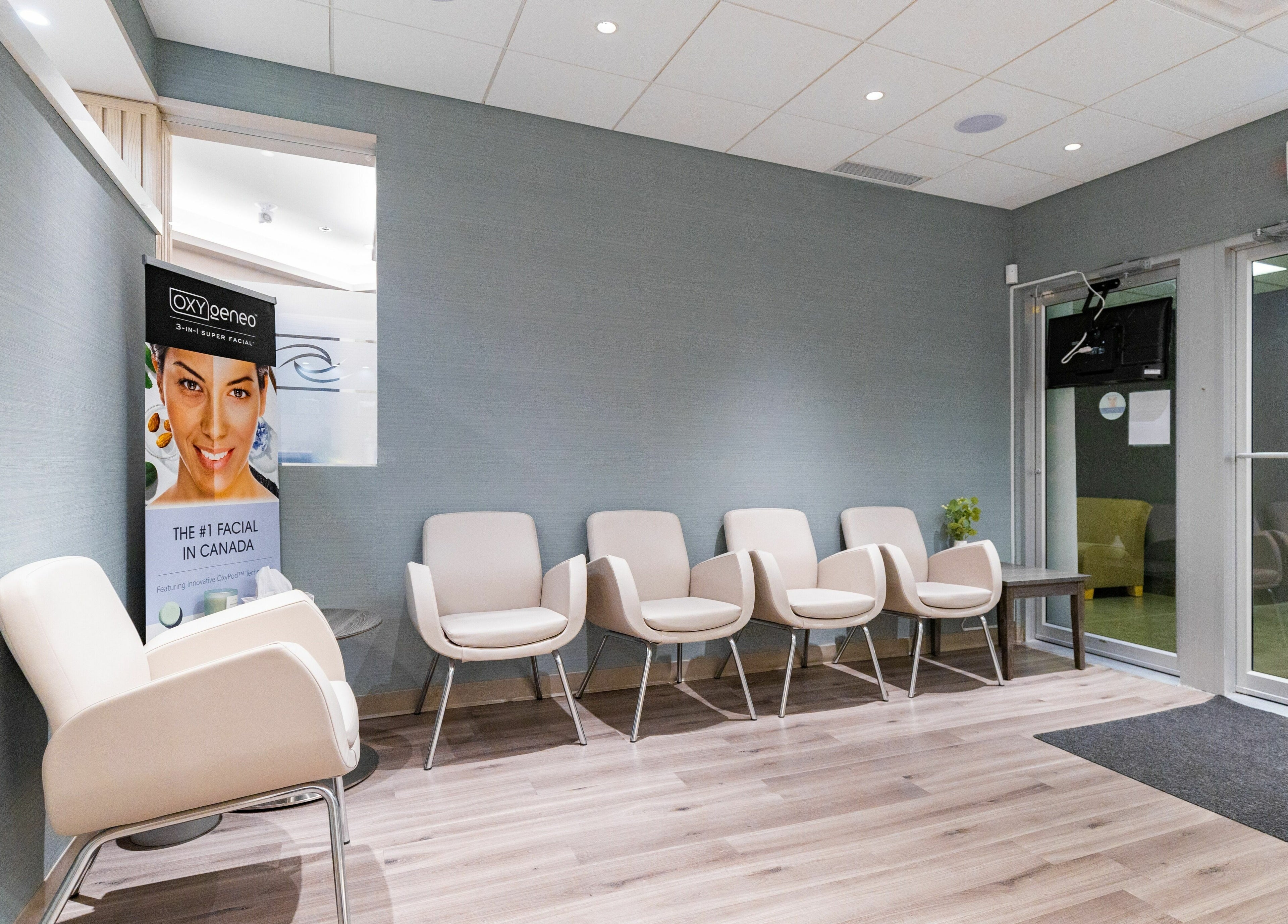 Modern waiting area at Eye Spa Aesthetics, Calgary, Alberta, CA with sleek chairs and calm ambiance.