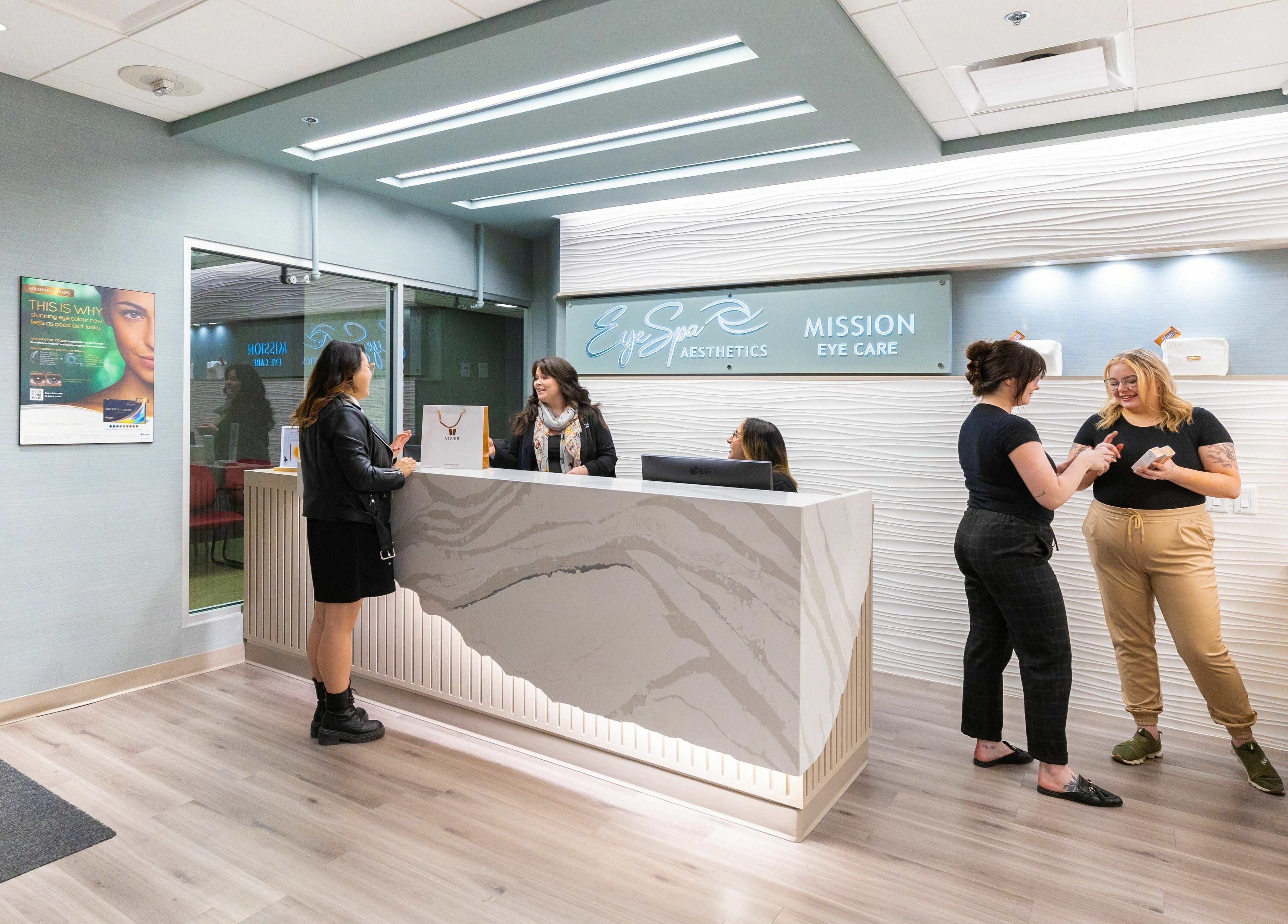 Eye Spa Aesthetics front desk with smiling staff, Calgary, Alberta, CA.