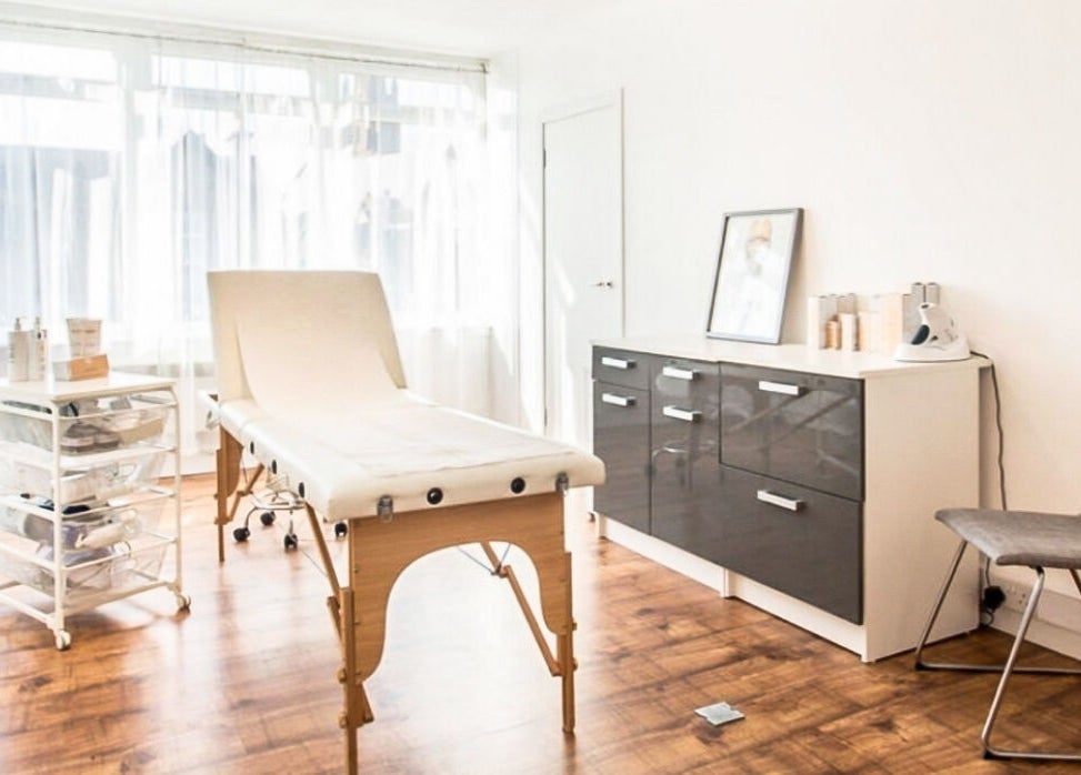Bright treatment room at Lady A Clinic, Ayr, Scotland, GB, with wooden floors and modern equipment.