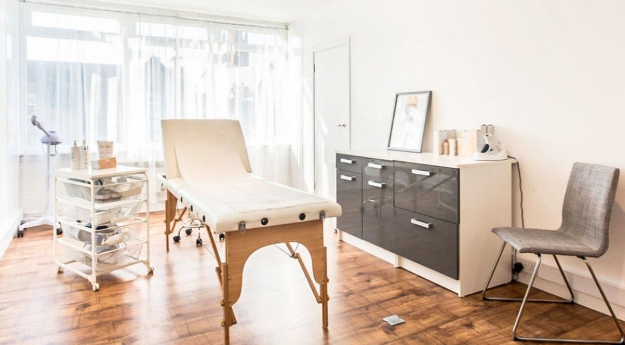 Bright treatment room at Lady A Clinic, Ayr, Scotland, GB, with wooden floors and modern equipment.
