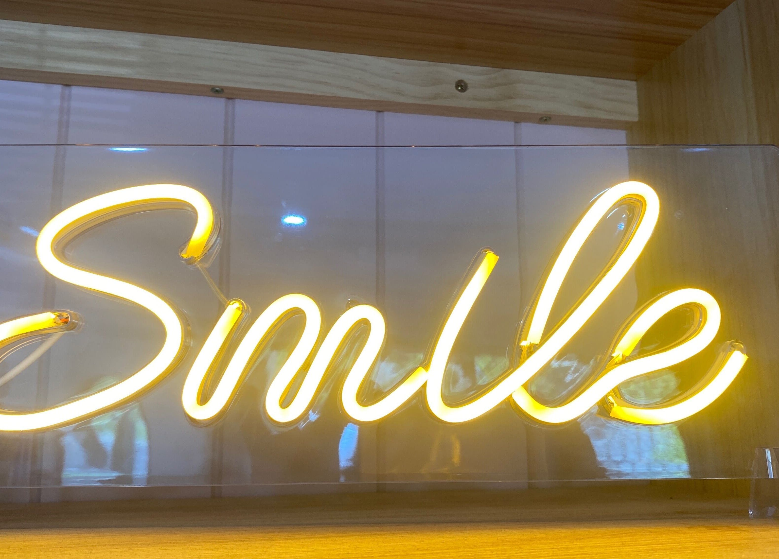 Neon smile sign at Jo Bailey Style, CURRUMBIN WATERS, Australia, AU, creating a welcoming ambiance.