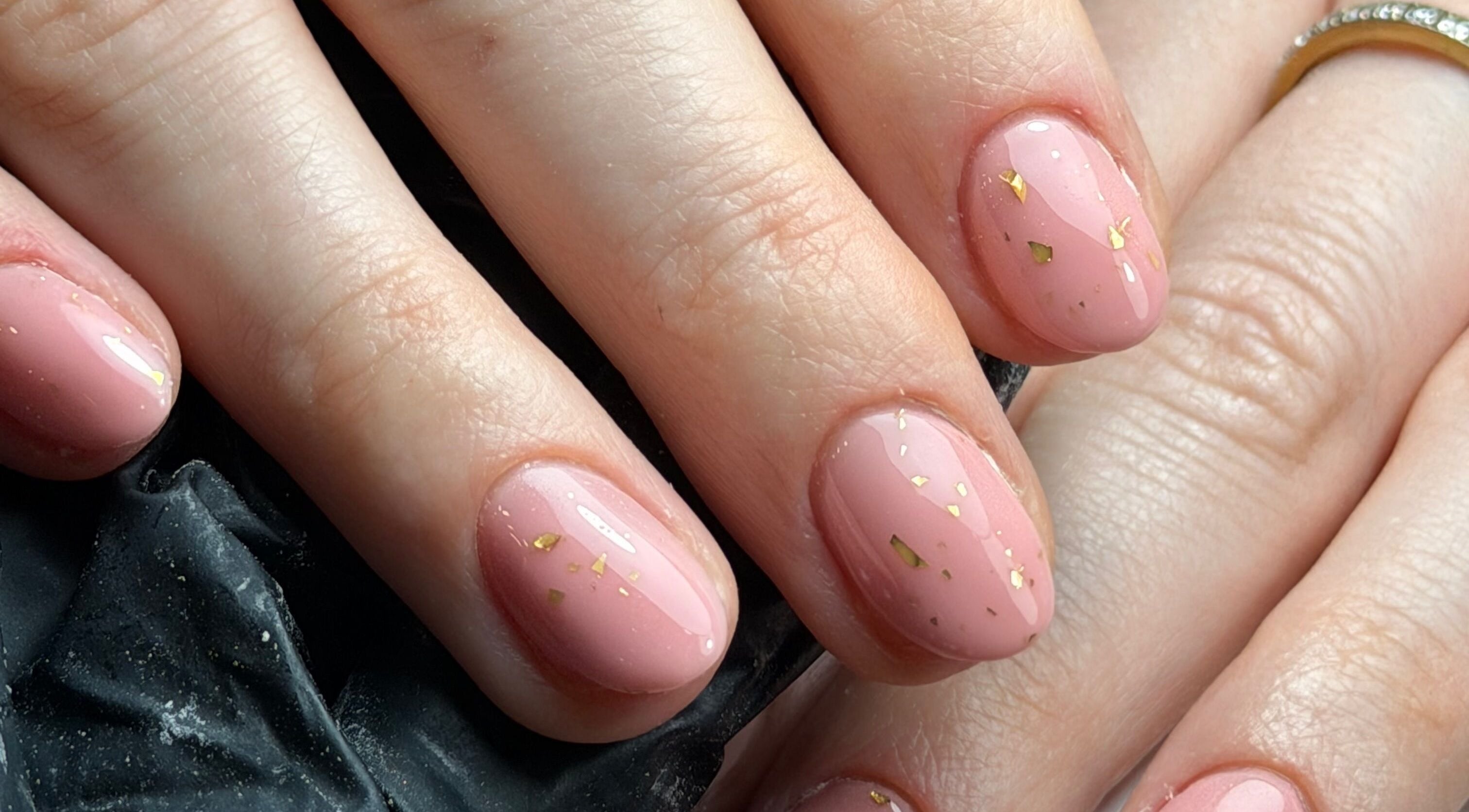 Elegant pink nails with gold accents at Molly Dolly’s Nails and Beauty in Solihull, England, GB.