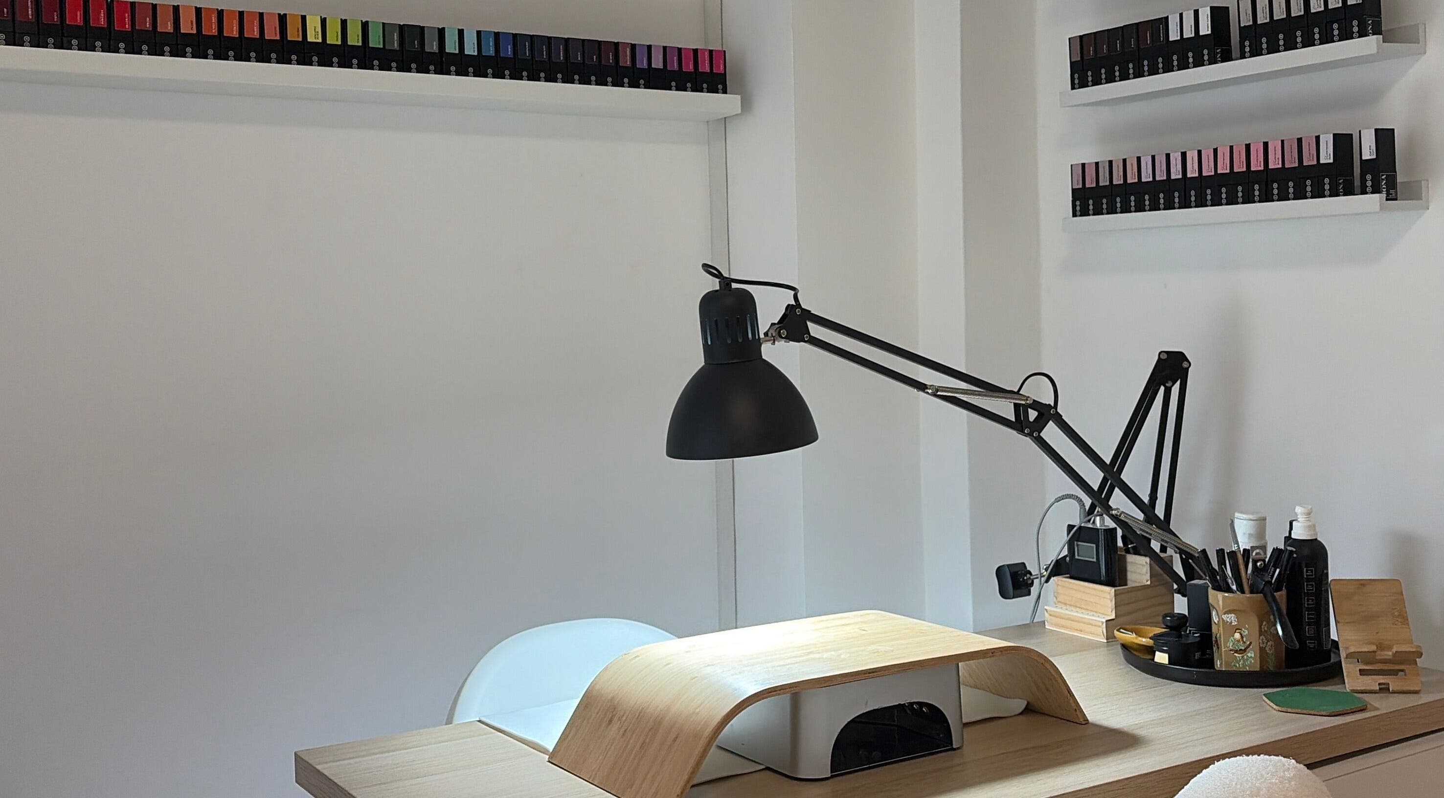 Modern nail station at Oh Lush Nails, Ystrad Mynach, Wales, GB with organized shelves and stylish lamp.