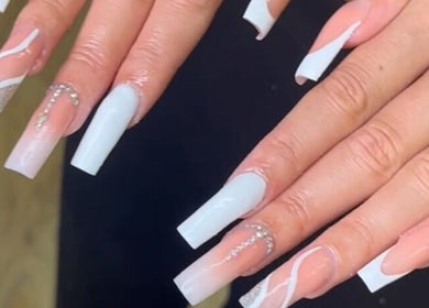 Stylish acrylic nails with white and silver designs at Hacrylicz, Seaton Delaval, England, GB.