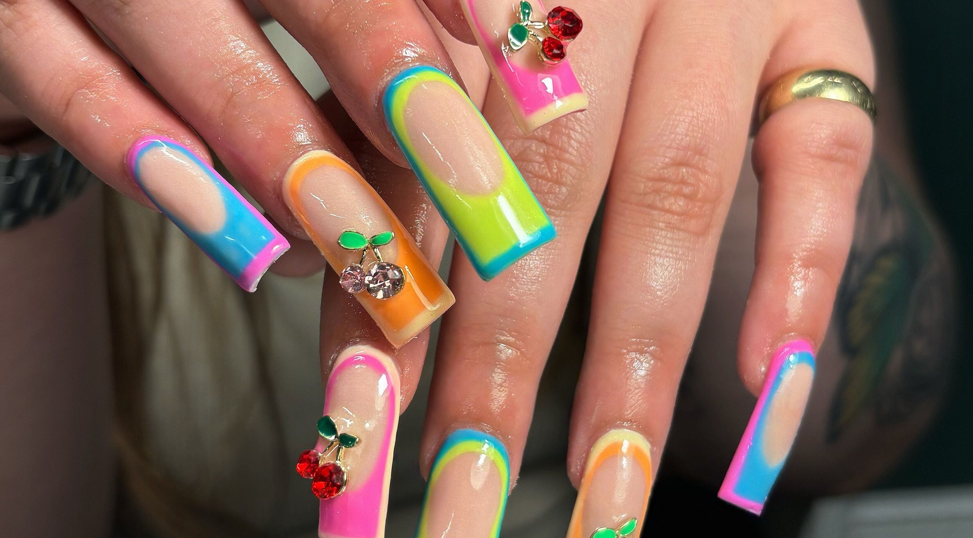 Colorful nail art with gem accents at Hacrylicz, Seaton Delaval, England, GB. A vibrant manicure showcase.