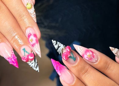 Vibrant nail art with floral and shell designs at Hacrylicz, Seaton Delaval, England, GB.