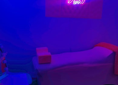 Cozy beauty room at Aleja LAkroy Beauty, Sterling Heights, Michigan, US with neon lighting and comfortable bed.