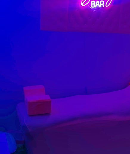 Cozy beauty room at Aleja LAkroy Beauty, Sterling Heights, Michigan, US with neon lighting and comfortable bed.