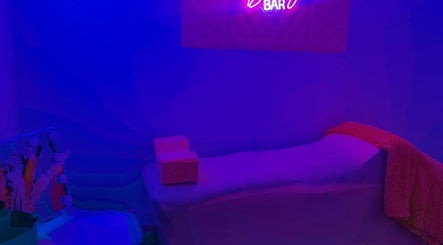 Cozy beauty room at Aleja LAkroy Beauty, Sterling Heights, Michigan, US with neon lighting and comfortable bed.