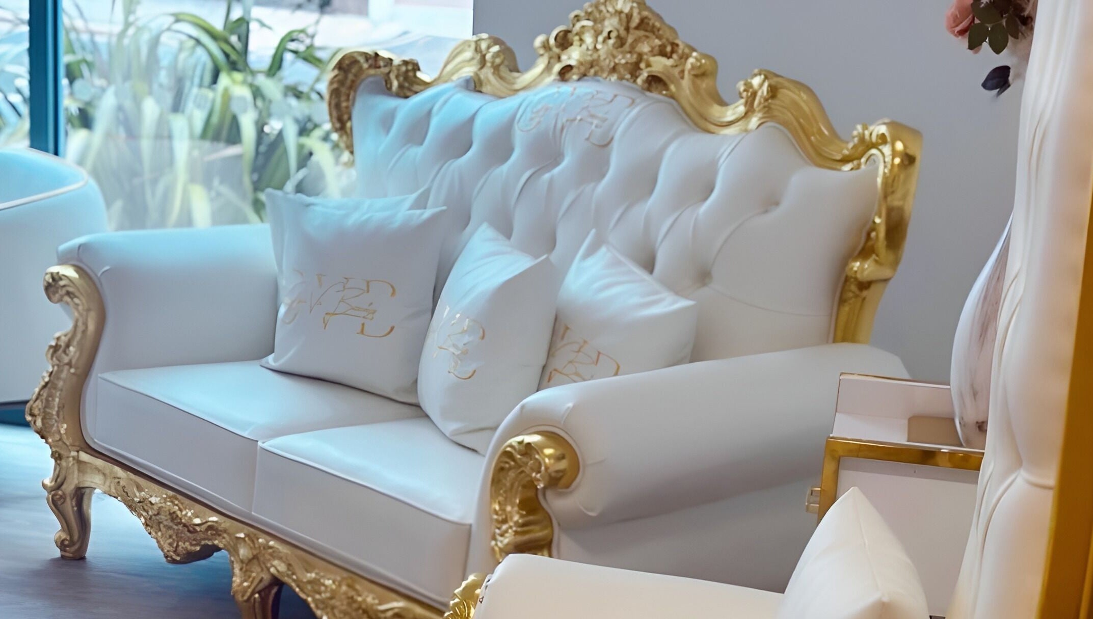 Elegant white and gold sofa at Gigi Vi Ltd, Plymouth, England, GB, showcasing luxury decor and comfort.