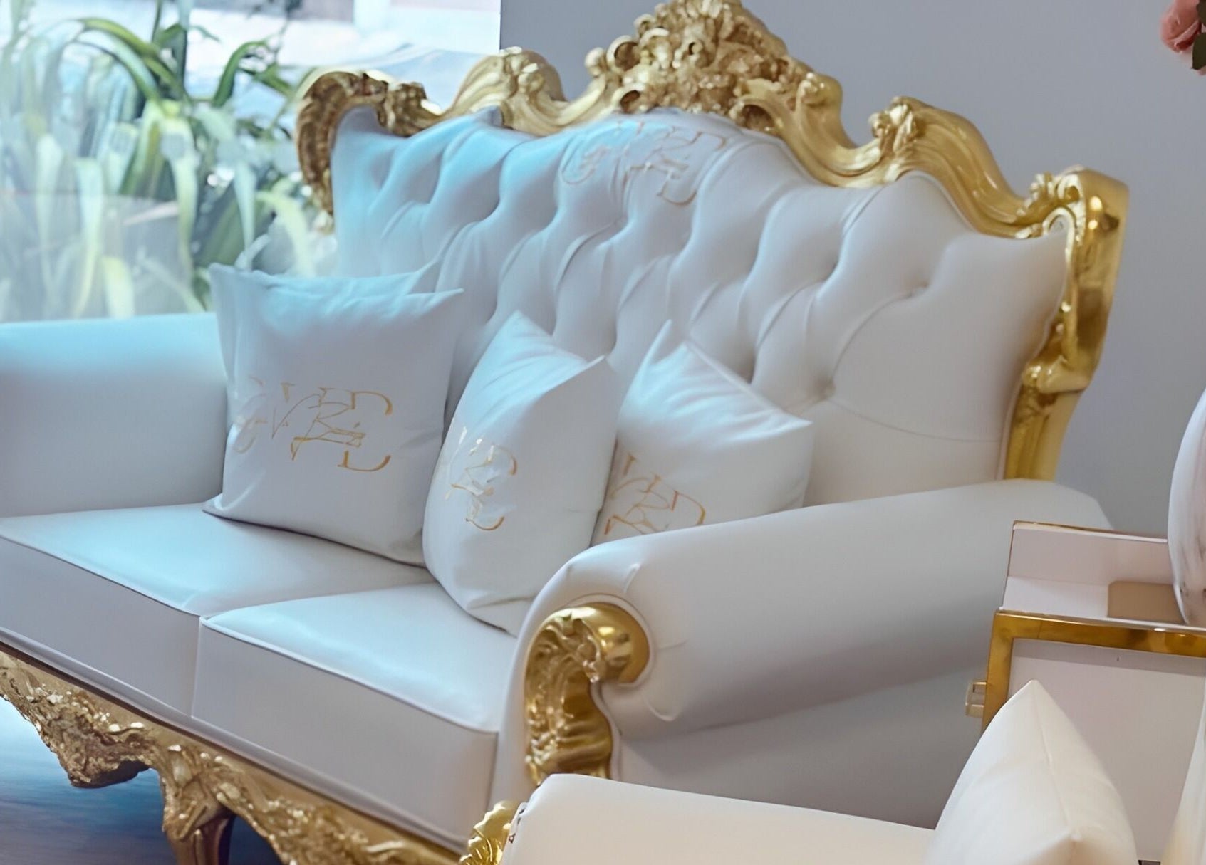 Elegant white and gold sofa at Gigi Vi Ltd, Plymouth, England, GB, showcasing luxury decor and comfort.