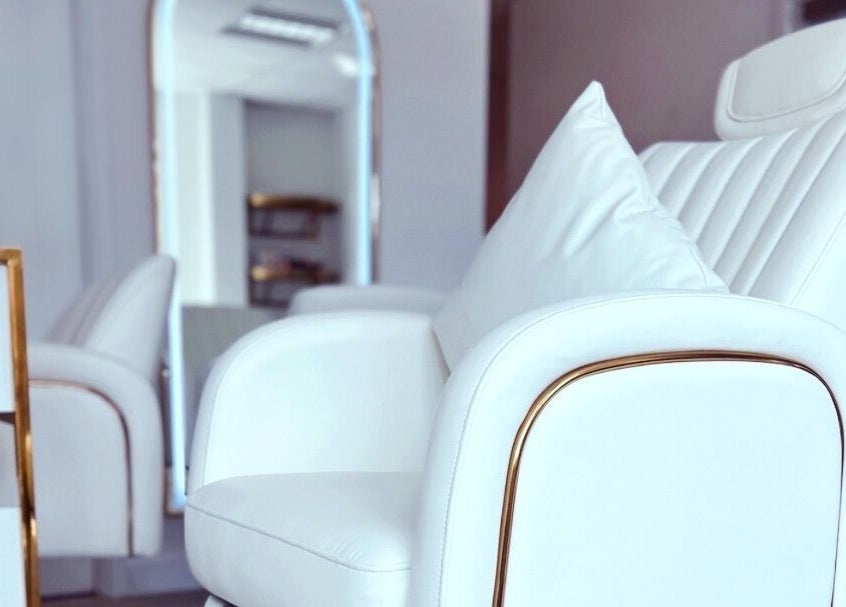Elegant white salon chair at Gigi Vi Ltd, Plymouth, England, GB, showcasing luxury and comfort.