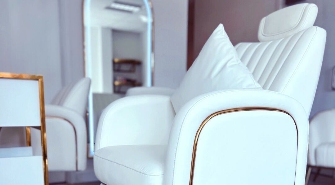 Elegant white salon chair at Gigi Vi Ltd, Plymouth, England, GB, showcasing luxury and comfort.