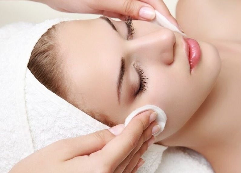 Facial treatment at Gigi Vi Ltd, Plymouth, England, GB. Skin care pampering with soft towel wrap.