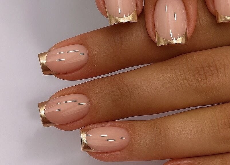 Stylish nails with gold tips at Gigi Vi Ltd, Plymouth, England, GB, showcasing fine nail artistry.
