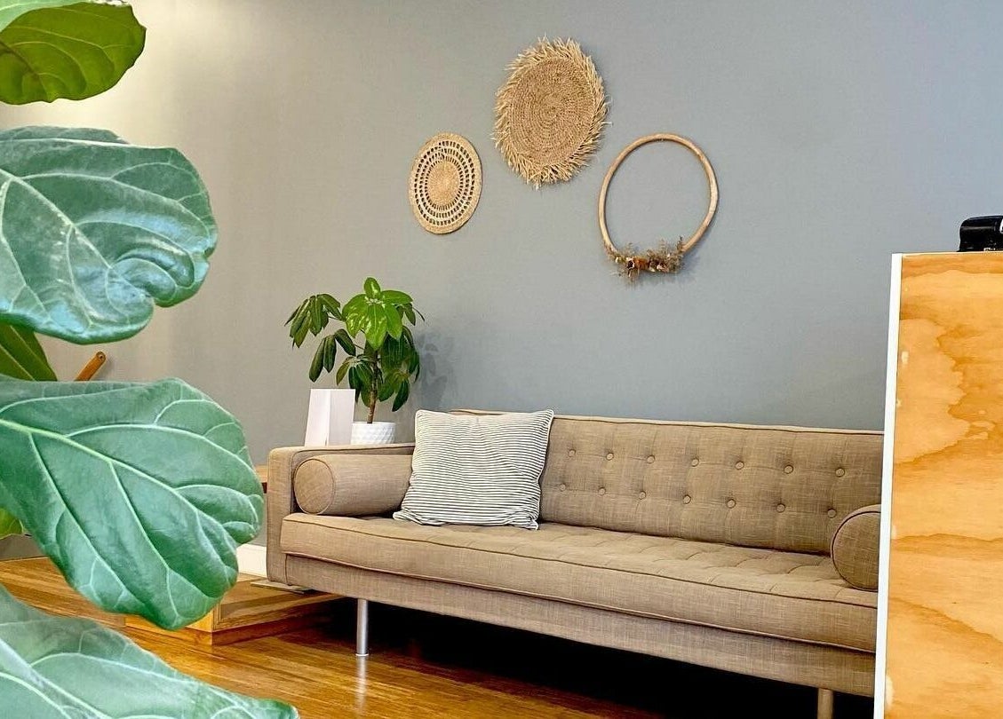 Cozy seating area at Essence Skin and Body in Launceston, Tasmania, AU with natural decor and a green plant.
