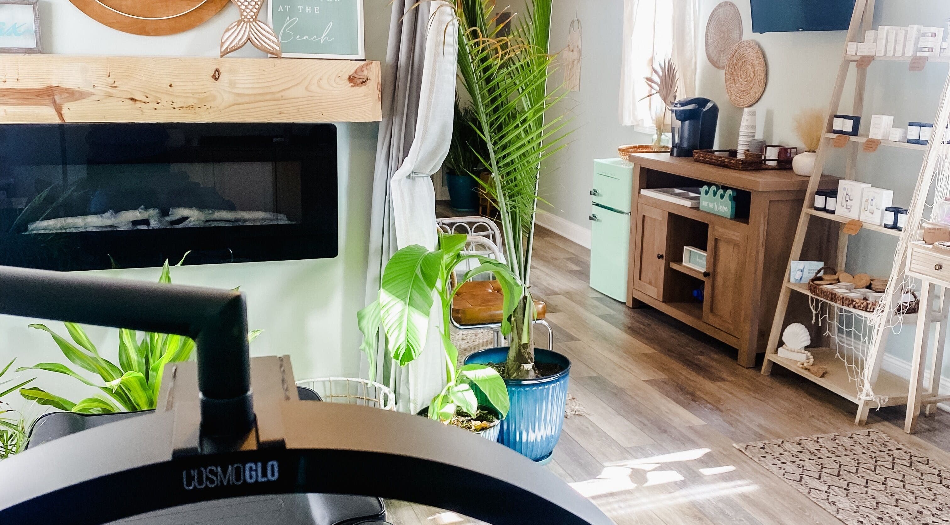 Inviting interior of Sea Salt Esthetics in Thor, Iowa, US with plants and cozy decor.