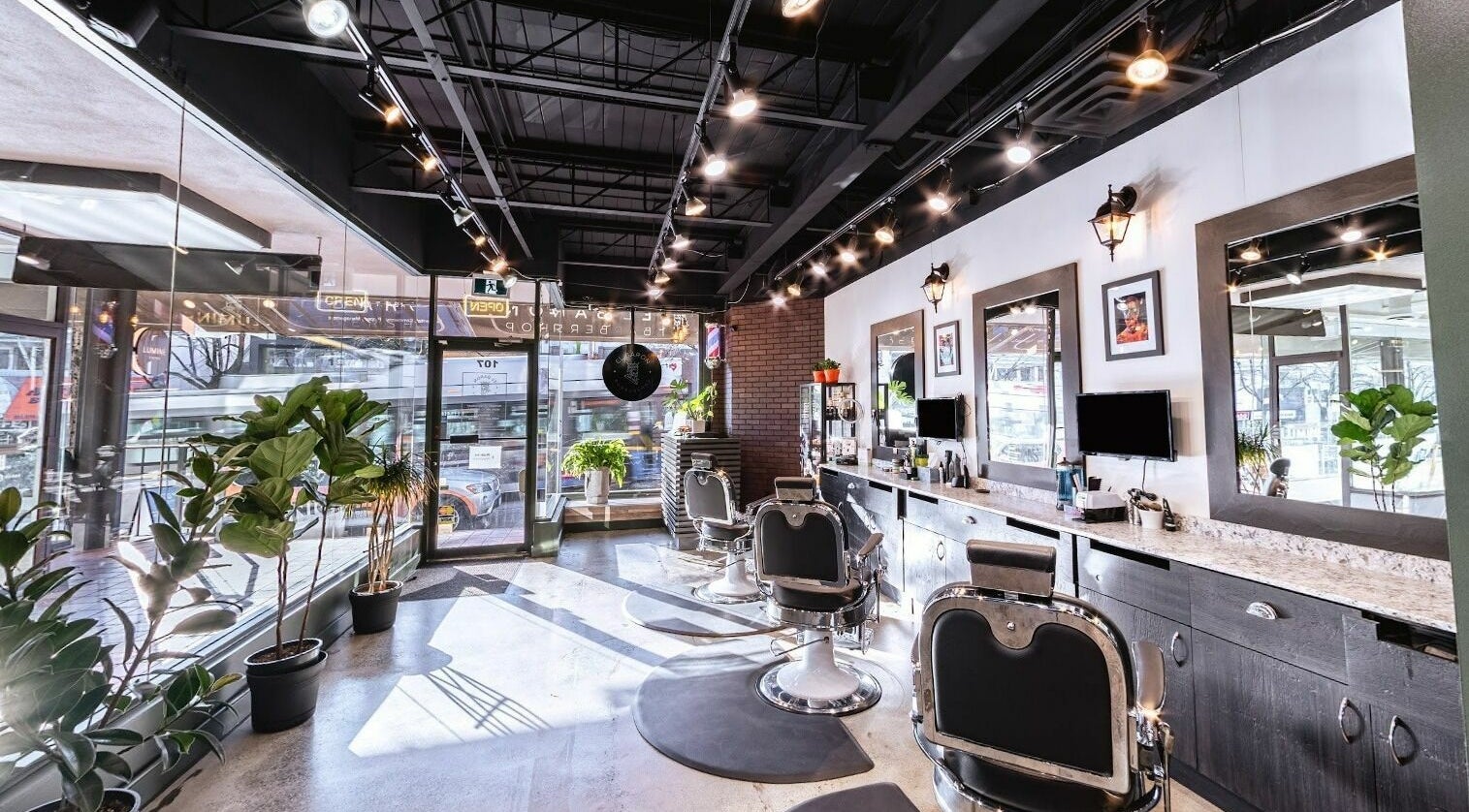 Sophisticated interior of El Baron Barbershop in Vancouver, British Columbia, CA with stylish chairs and mirrors.