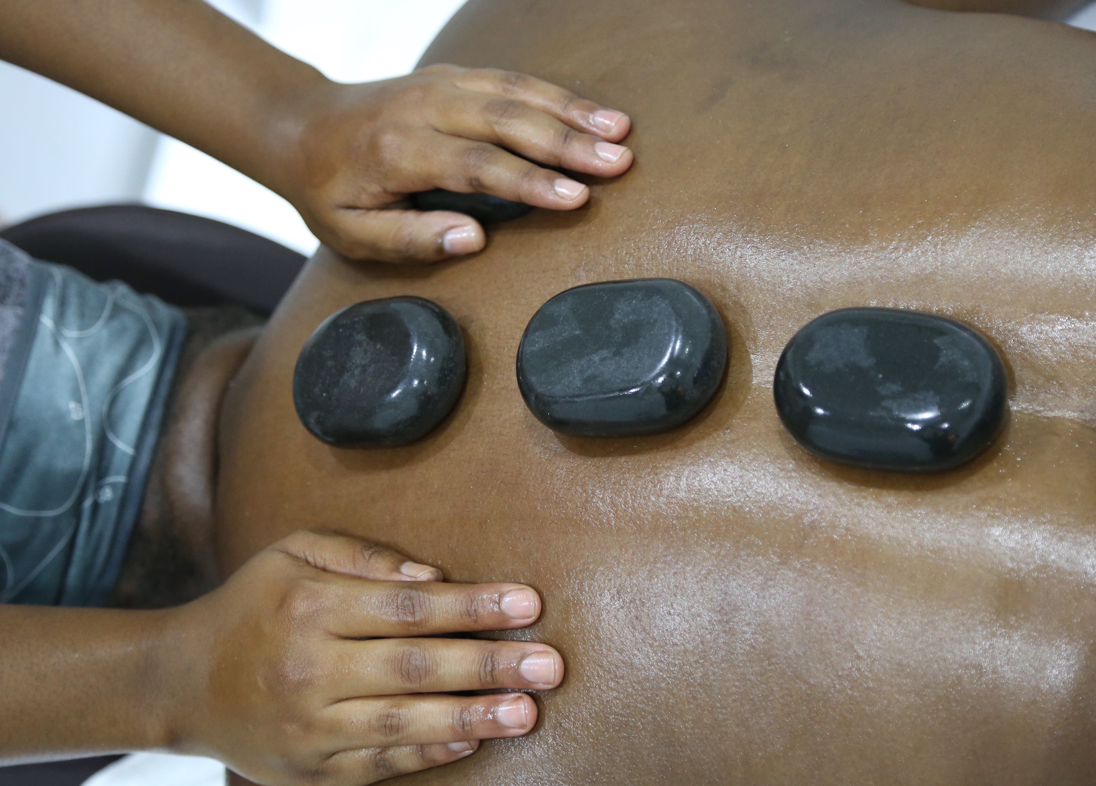Hot stone massage at Nice Nails and Wellness in Johannesburg, Gauteng, ZA, promoting relaxation and wellness.