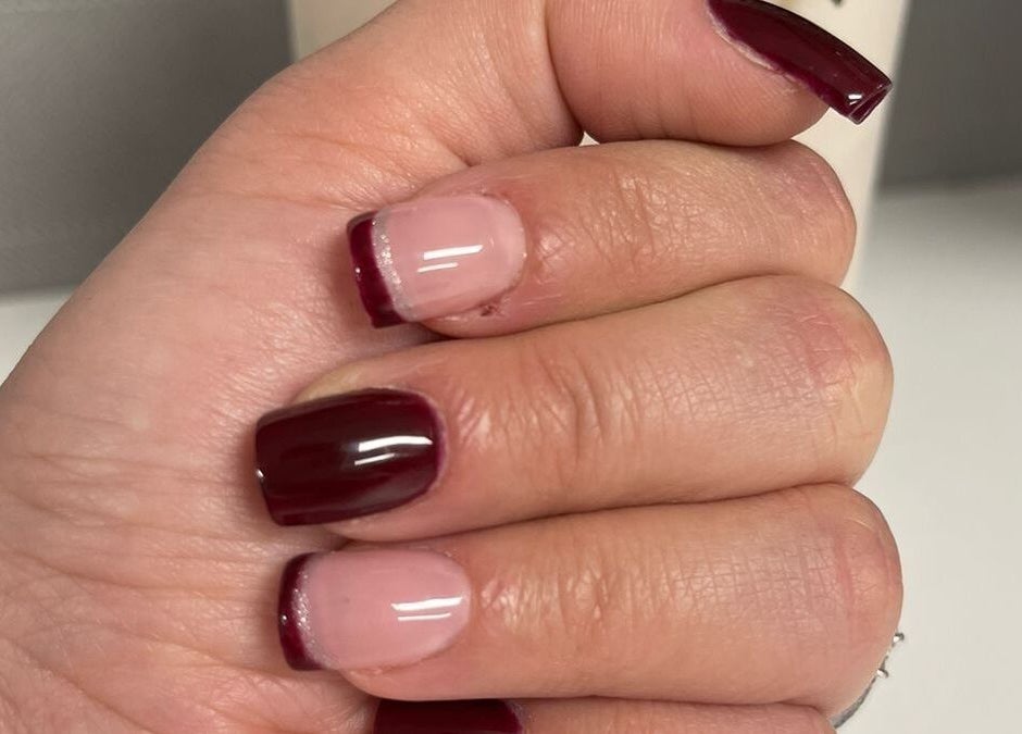Stylish maroon and nude French manicure by Nice Nails and Wellness in Johannesburg, Gauteng, ZA.