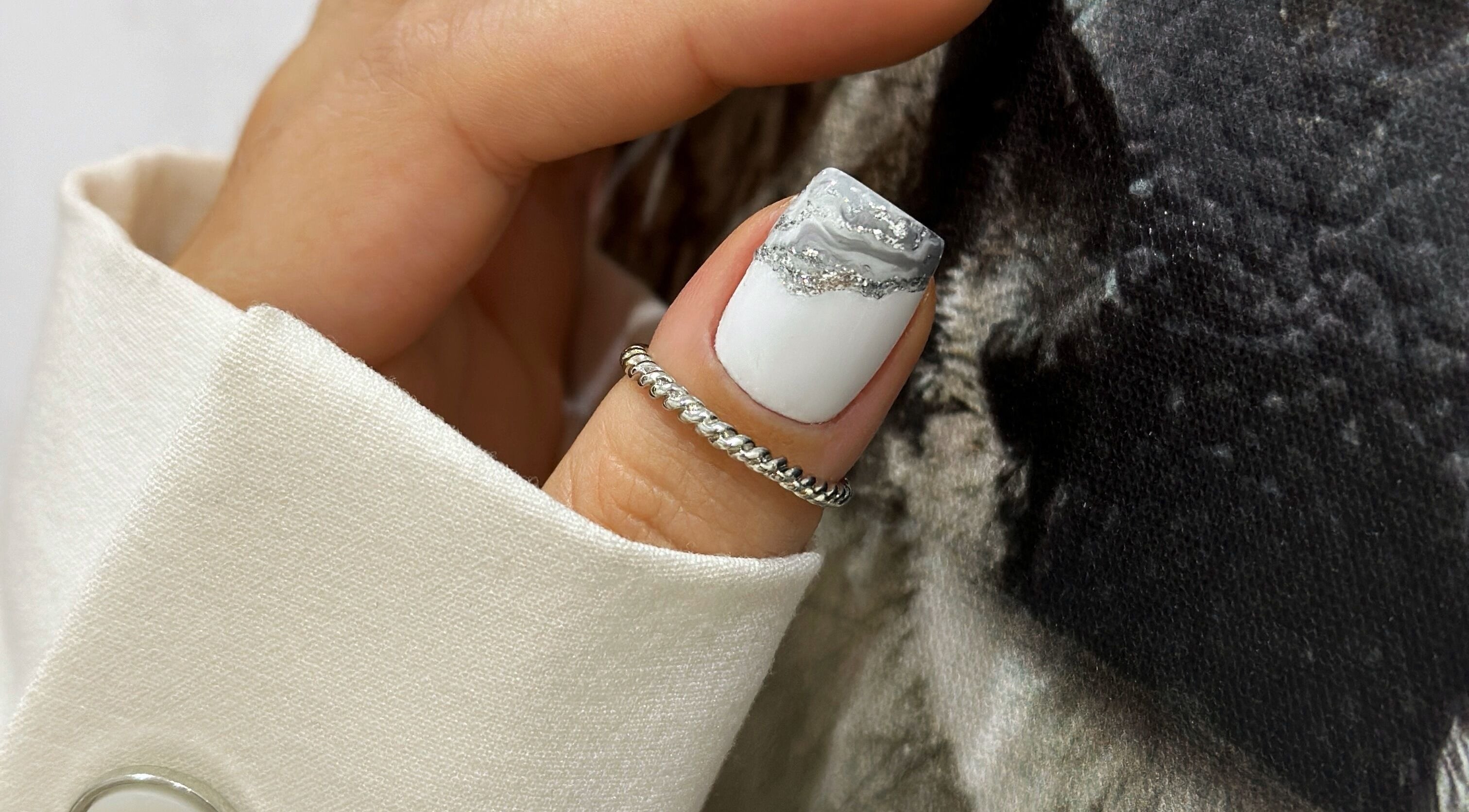 Close-up of marble nail art at Siedova Nails, Sydney, New South Wales, AU, featuring white and silver hues.