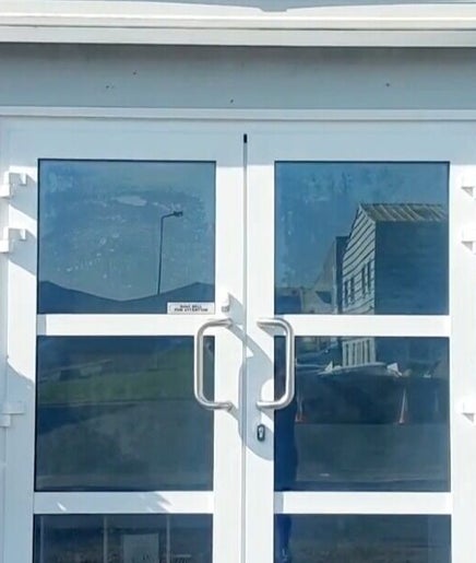 The Skin Pro .ie front entrance in Waterford, County Waterford, IE, featuring glass doors and decorative plants.