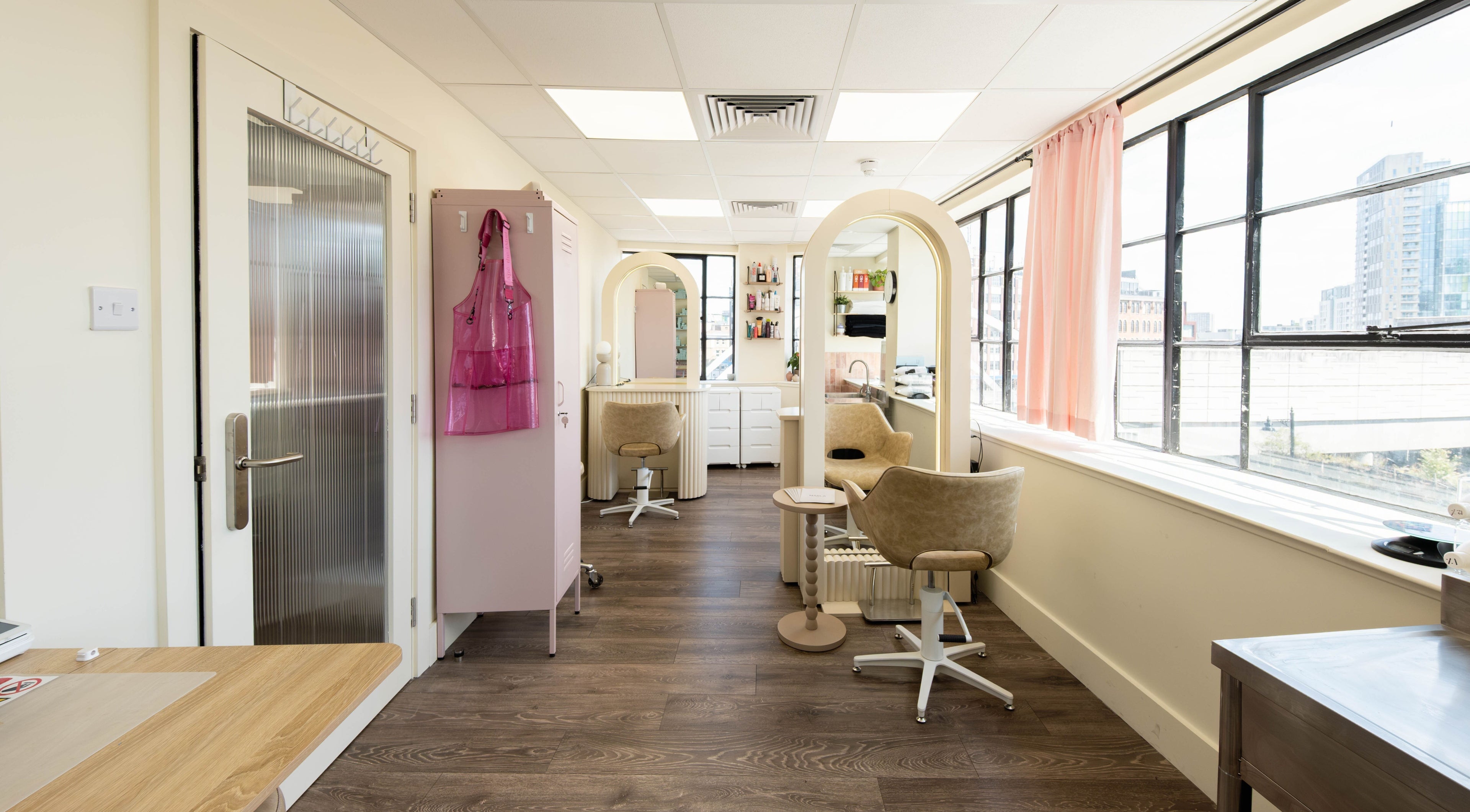 Bright interior of Marla Hair salon in London, England, GB with modern decor and salon chairs.