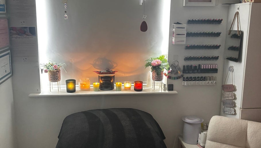 Cozy beauty room at Gemmy Gorgeous, Leeds, England, GB, with candles and nail polish display.