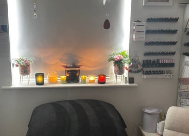 Cozy beauty room at Gemmy Gorgeous, Leeds, England, GB, with candles and nail polish display.