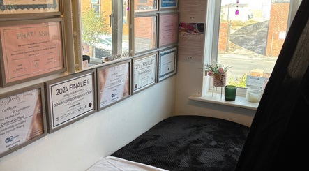 Certificates and awards on wall at Gemmy Gorgeous, Leeds, England, GB, highlighting salon accomplishments.