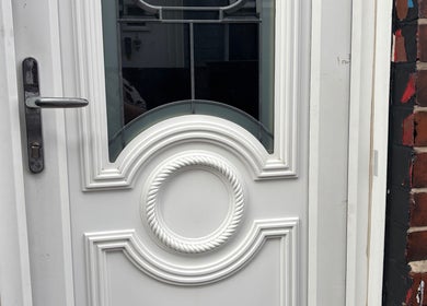 Charming white door with intricate design at Gemmy Gorgeous, Leeds, England, GB.