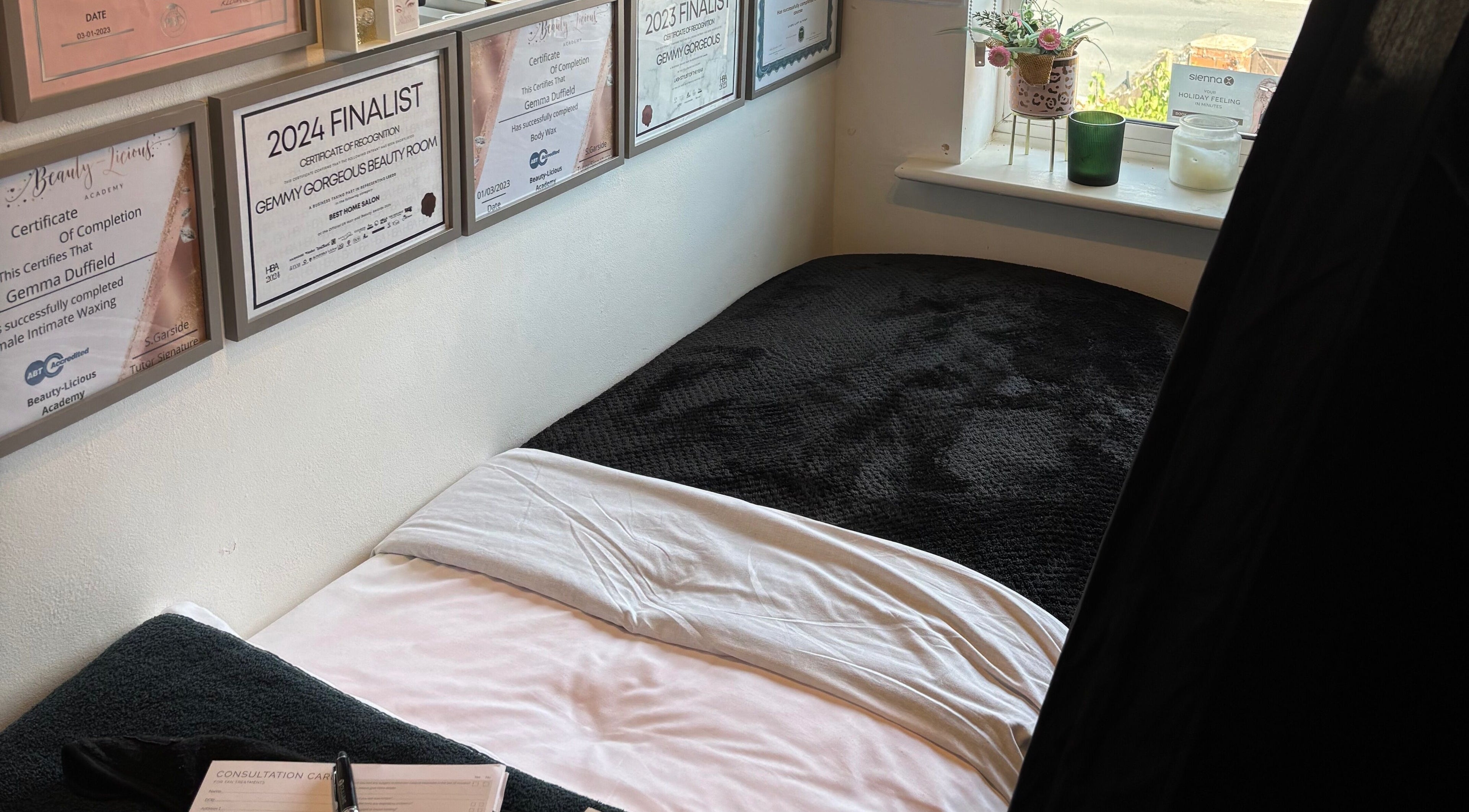 Gemmy Gorgeous in Leeds, England presents a serene beauty treatment room with awards on the wall.