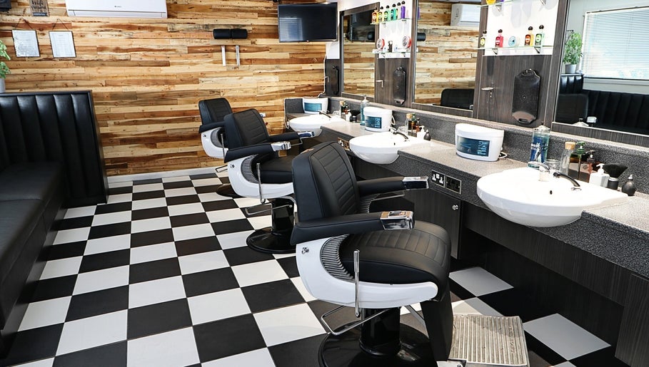 Modern barber chairs in sleek interior of Coal House Cuts, Upminster, England, GB offering premium styling.
