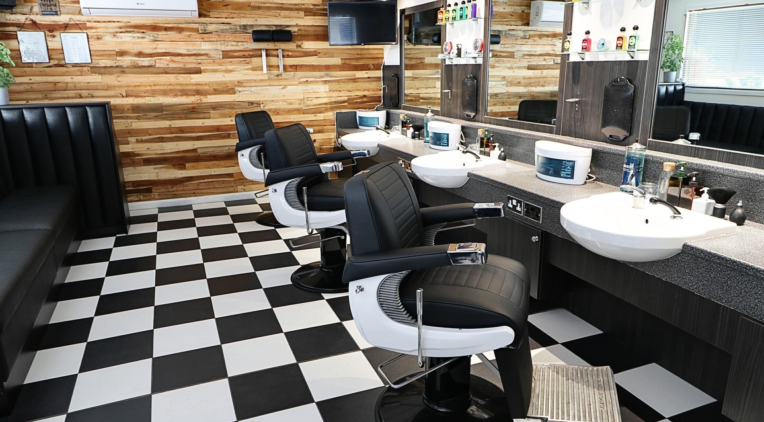 Modern barber chairs in sleek interior of Coal House Cuts, Upminster, England, GB offering premium styling.