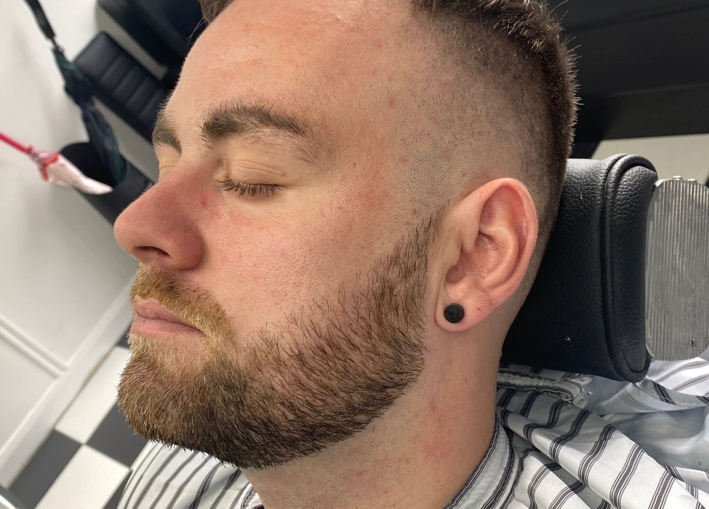 Close-up of a man with a fresh haircut at Coal House Cuts, Upminster, England, GB.
